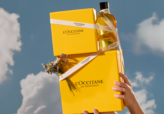 Woman holding L'OCCITANE gift box, L'OCCITANE unisex gifting