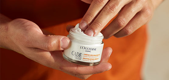A man about to apply the L'OCCITANE Cade Revitalising Cream