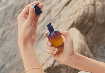 Woman holding L'OCCITANE Overnight Immortelle Reset Serum 