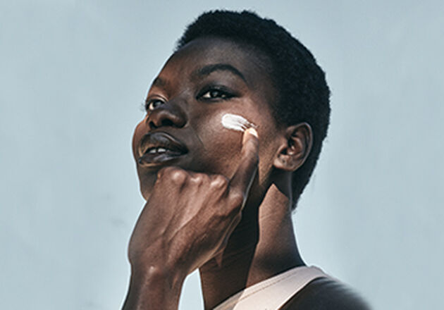 A woman applying L'OCCITANE Shea face cream