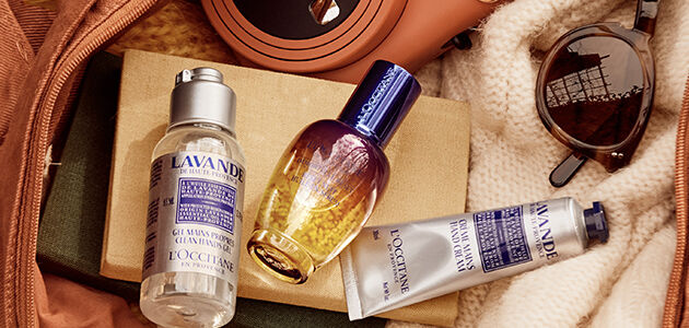 The image shows the L'OCCITANE Immortelle Reset Overnight serum inside a bag amongst other products
