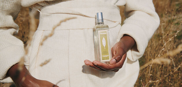 A woman holding L'OCCITANE Verbena Classic Eau de toilette