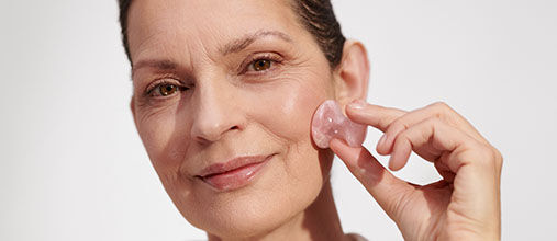Woman massaging L'OCCITANE Skincare to prevent ageing 