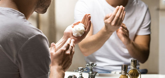 A man using the L'OCCITANE Cade Refreshing Shaving Gel