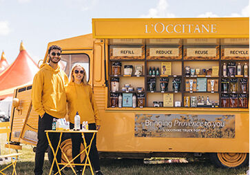 L'OCCITANE Brand Ambassadors standing next to the iconic Yellow L'Occi Truck 