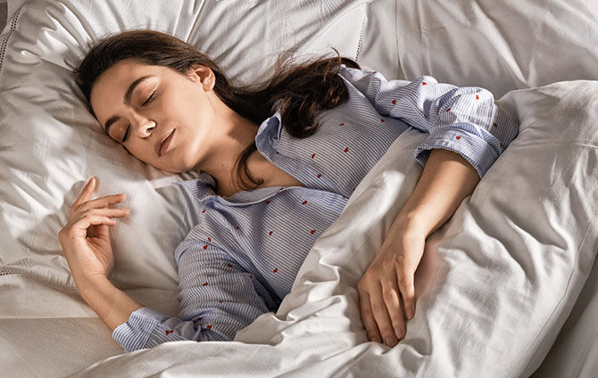 Woman sleeping deeply after using L'OCCITANE Relaxing Pillow Mist