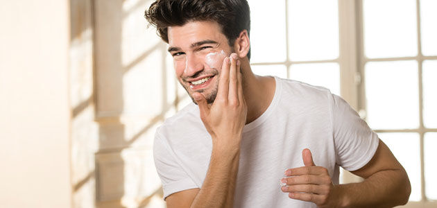A man moisturising his face with L'OCCITANE Cade Revitalising Cream