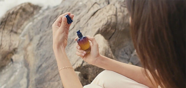 Woman holding L'OCCITANE Immortelle reset serum