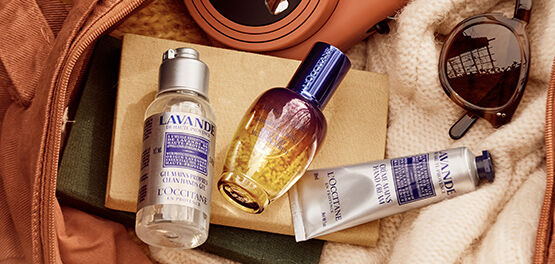 The image shows the L'OCCITANE Immortelle Reset Overnight serum inside a bag amongst other products