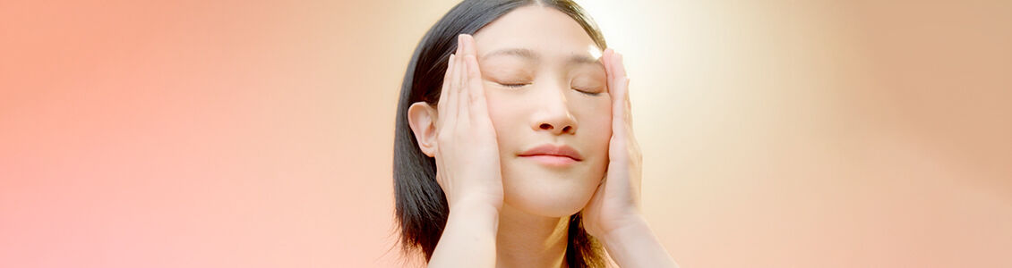 A woman massaging her face
