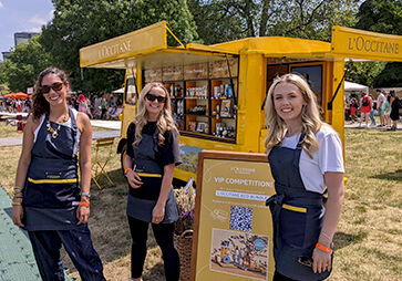 L'OCCITANE Brand Ambassadors standing next to the iconic L'Occi Yellow Truck at Taste of London Festival 2023, London, Regents Park   