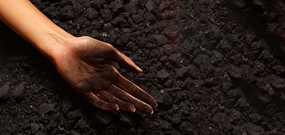 Woman's hand covered with coal, L'OCCITANE Uses Sustainable Methods of Production, Cauldrons heated with Steam