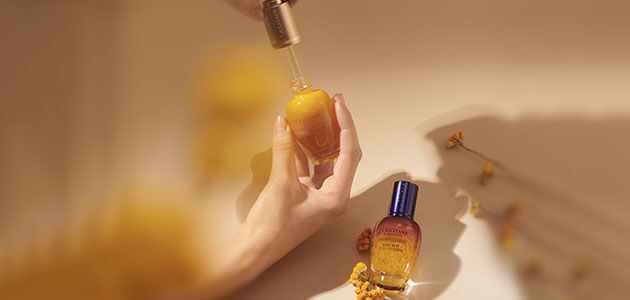 The image shows the L'OCCITANE Immortelle Divine Serum and L'OCCITANE Immortelle Reset Overnight serum
