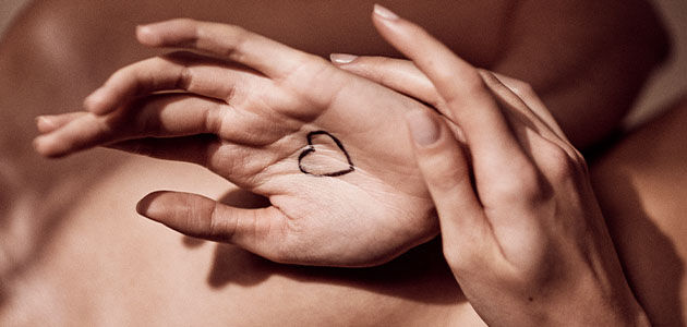 This image shows a hand-drawn heart  on someone's hands