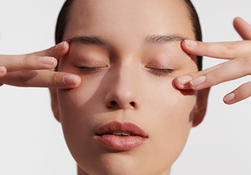 Woman applying L'OCCITANE Immortelle Eye Balm 