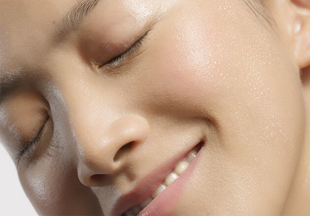 This image shows the face of a woman smiling