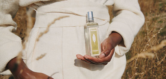 A woman holding L'OCCITANE Verbena Classic Eau de toilette