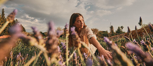 Woman walking through Lavender Field in Provence 
