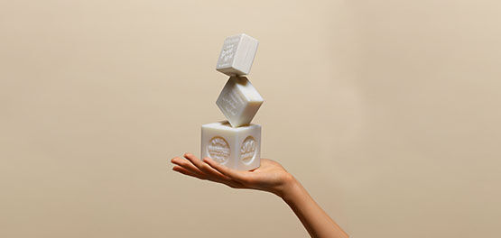 Woman holding L'OCCITANE Bonne M&egrave;re Extra Pure Soaps, Savon de Marseille, Provence 