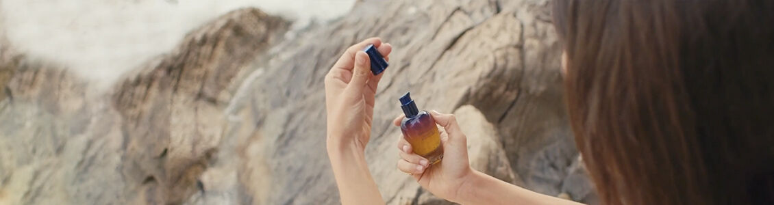 Woman holding L'OCCITANE Immortelle reset serum