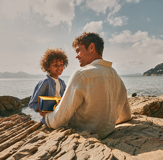 A son giving a L'OCCITANE gift Box to his dad