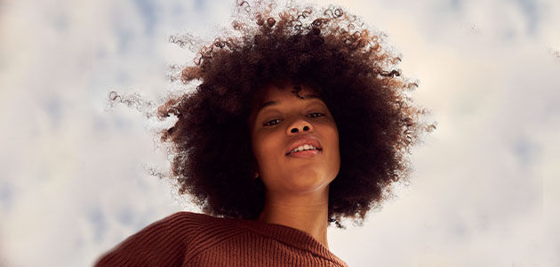 The image shows a young woman smiling