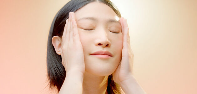 A woman massaging her face