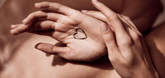 This image shows a hand-drawn heart  on someone's hands