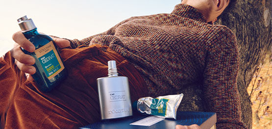 The image shows a man holding the L'OCCITA Cap Cedrat Shower Gel 