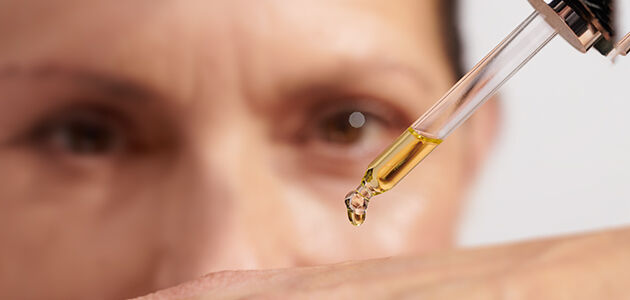 Image showing a scientific expert holding a dropper