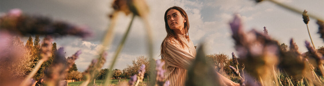 Image showing a woman walking through a lavender field in Provence