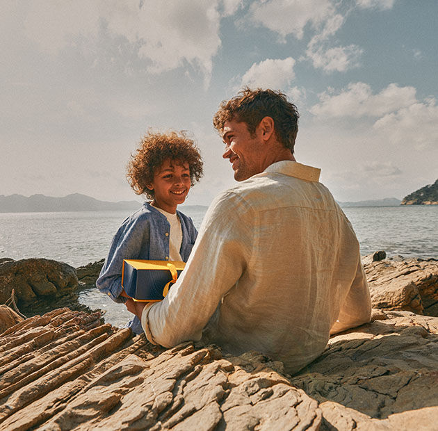 A son giving a L'OCCITANE gift Box to his dad